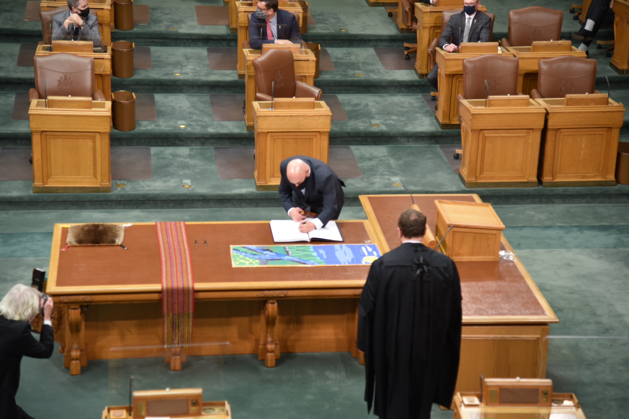 Terry signing the register as a new MLA